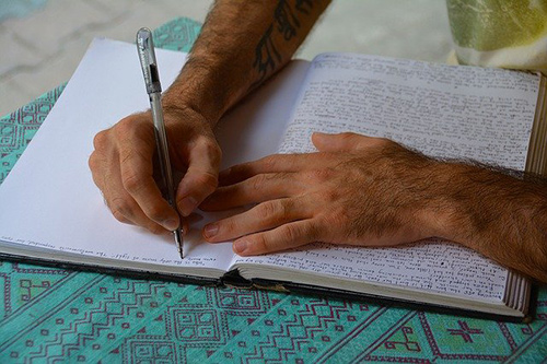 Person writing in notebook
