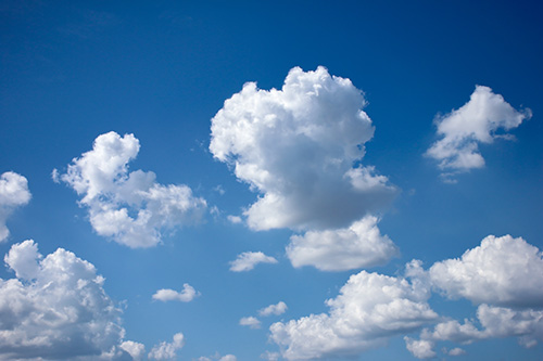 Puffy clouds in blue sky
