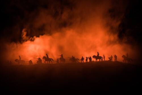 American Civil War Concept. Military silhouettes fighting scene on war fog sky background. Attack scene.