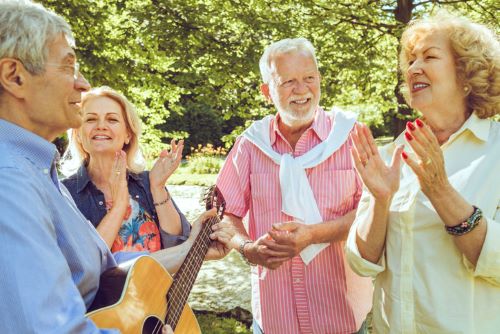 people singing happy active seniors enjoying in nature together and having fun