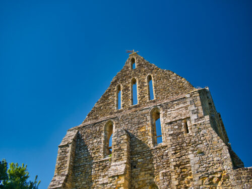 The ruins of the end wall of the abbey church at Battle in East Sussex, UK, location of the Battle of Hastings in 1066. Taken on a sunny day with a blue sky and no clouds.