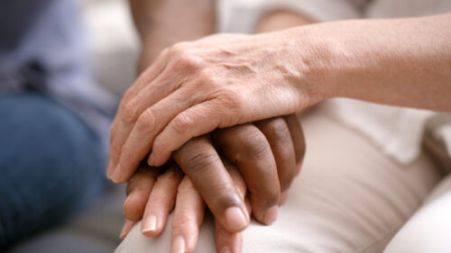 Holding hands, support and couple with empathy, trust and helping for mental health problem, counseling or therapy zoom. Diversity people love, care and hand holding for depression, death or bad news Holding hands, support and couple with empathy, trust and helping for mental health problem, counseling or therapy zoom. Diversity people love, care and hand holding for depression, death or bad news.