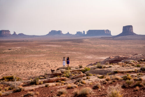 Two Teenage Navajo Native American Girls Looking over the Vast Desert in Northern Arizona Monument Valley Tribal Park Navajo Reservation Two Teenage Navajo Native American Girls Looking over the Vast Desert in Northern Arizona Monument Valley Tribal Park Navajo Reservation