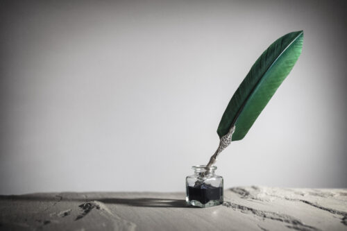 Quill pen and inkwell background concept for literature, writing, author and history