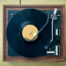 A dusty, dirty, vintage wood and plastic record player from high angle view (directly above)), with retro formica 1960's table. Copy space on table and record; horizontal