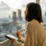 Asian woman writing her to-do list on digital tablet, writing down her goals, determined to stay motivated and on track to accomplish new things in the New Year