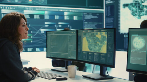 Cyber operations center with governmental hackers working on digital security activities during hybrid war. Specialists team ensuring security and malware detection, cyber surveillance.
