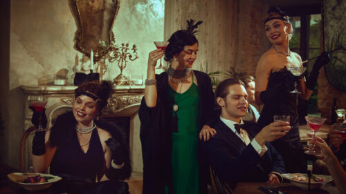 Stylish vintage friends toasting in a glamorous evening setting.